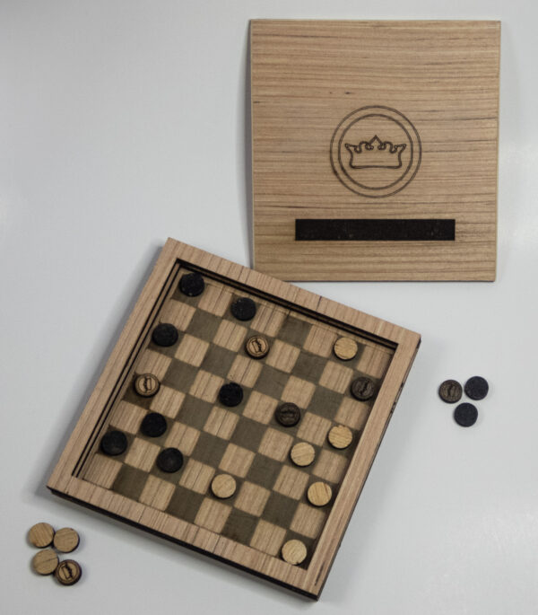 Wooden travel checkers game with lid off and a game in progress.