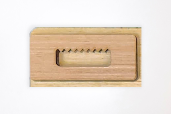 Wooden sawtooth hanger on the back of a puzzle board.