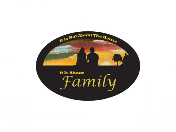 Oval-shaped sign with hand-painted sunset background and silhouette of a couple and a house. Cutout text says "it is not about the house, it is about family."