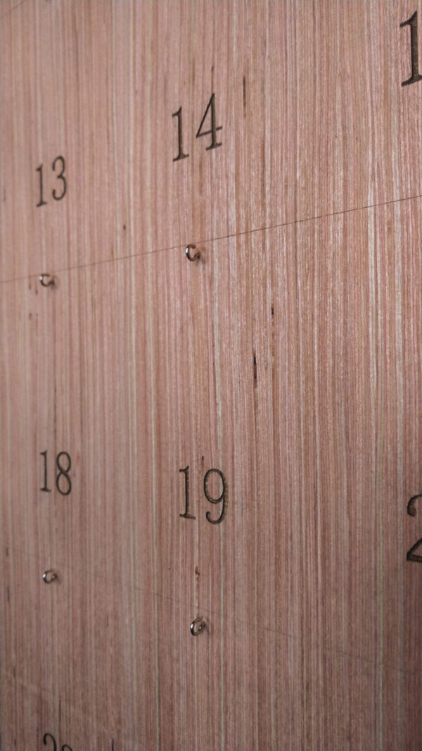 Poplar board with laser engraved numbers and small eye hooks.