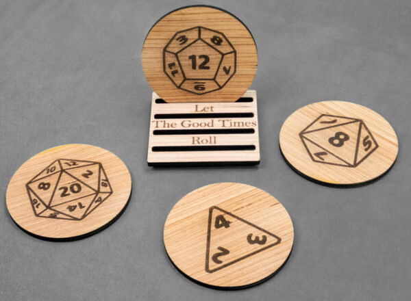 Set of 4 laser engraved wood coasters. A coaster featuring a D-12 die is on a stand that reads "Let the good times roll." 3 additional coasters are laid around the stand, each featuring a different die.