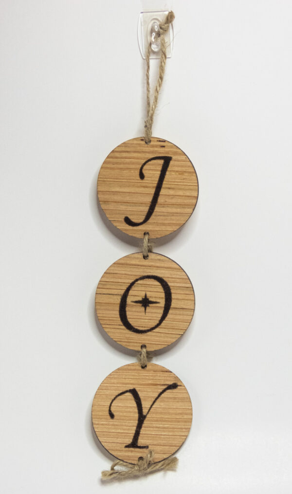 3-tiered wood round sign. Each round features a letter to spell out the word "Joy" the O has a stylized star in the middle.