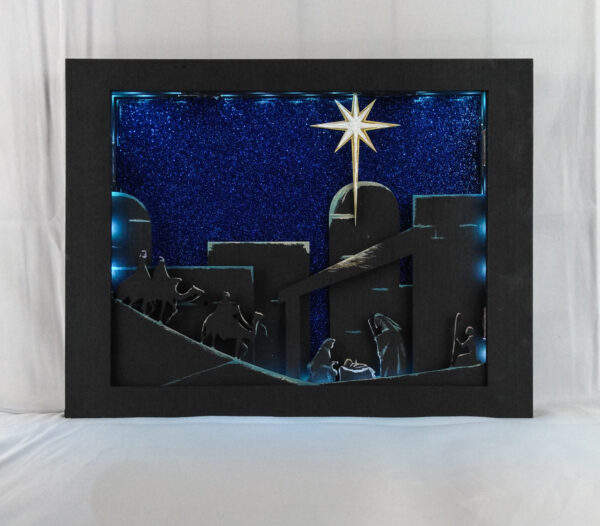 Beautiful 3d lightbox featuring a simple nativity scene illuminated with soft blue light.