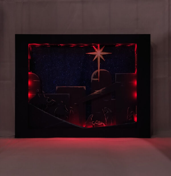 Beautiful 3d lightbox featuring a simple nativity scene illuminated with red light.