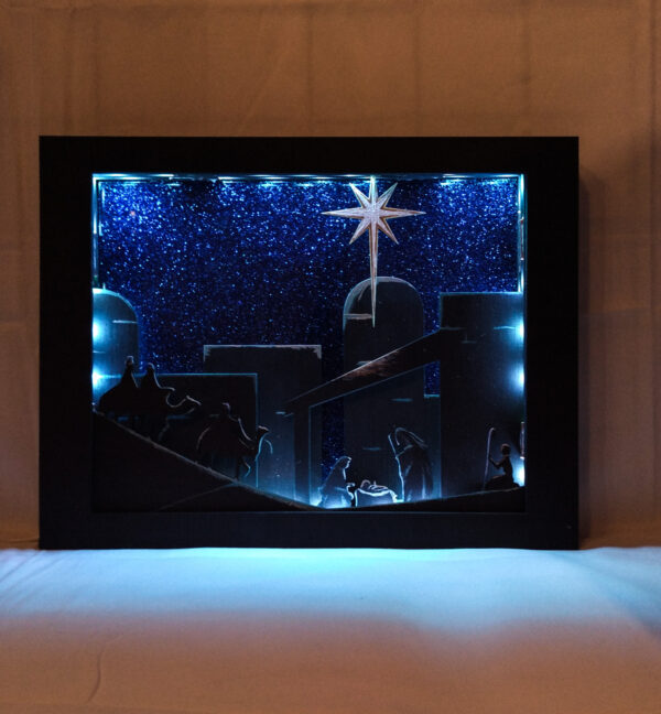 Beautiful 3d lightbox featuring a simple nativity scene illuminated with white light.