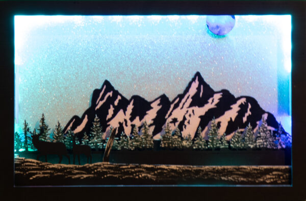 Beautiful 3d lightbox featuring a snowy mountain scene with a glittery white background reflecting the soft blue light through the scene.