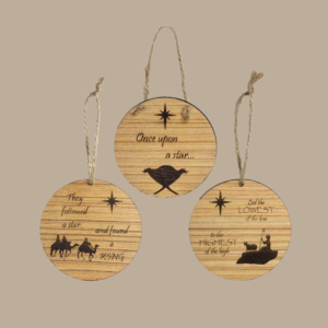 3 Wood ornaments, featuring images and phrases relating to the birth of Jesus Christ.